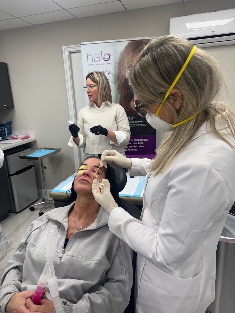 Dr. Beth Collins applies the green bismuth mask to a patient’s face following a croton oil peel.